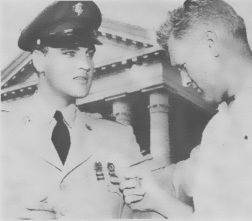 Elvis daddy inspects his medals