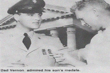 Vernon admires his son's medals